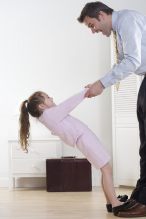 Girl and Working Father Holding Hands