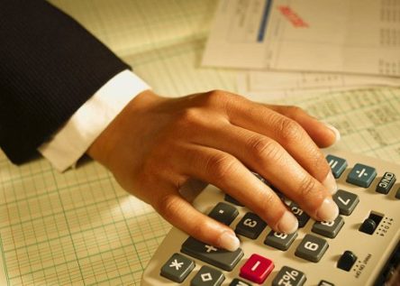hand on calculator